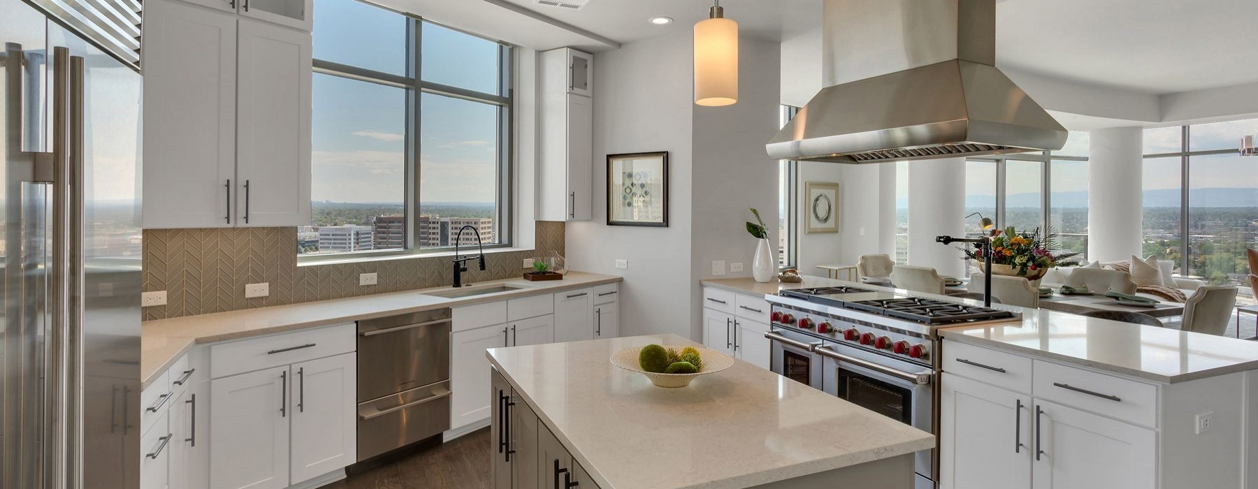 Wide open and bright kitchen area with high-up view of the city