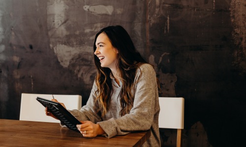 Woman laughing while working